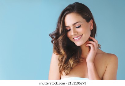 Nothing Beats A Good Hair Day. Studio Shot Of A Beautiful Young Woman Posing Against A Blue Background.