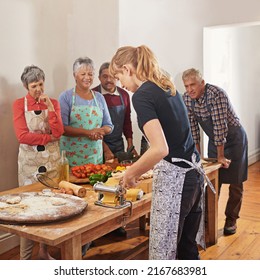 Nothing brings people together like good food. Shot of a group of seniors attending a cooking class. - Powered by Shutterstock