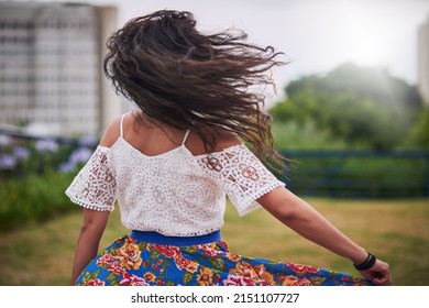 Nothing Can Contain Her Free Spirit. Rearview Shot Of A Young Woman Dancing In The City.