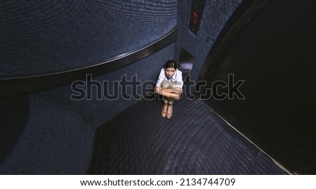 Nothing to do but wait. Distorted shot of a young woman trapped in an elevator.