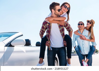 Nothing but good friends. Two beautiful young couples having fun near their white convertible   - Powered by Shutterstock