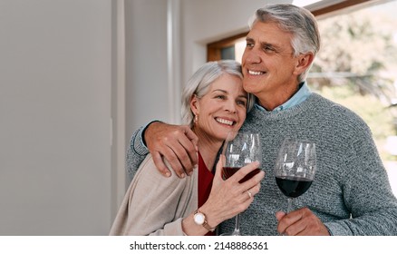 Nothing says romance like sharing some red wine. Shot of a happy mature couple having red wine together during a relaxing day at home. - Powered by Shutterstock