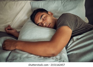 Nothing soothes the soul like a deep sleep. Shot of a young man sleeping peacefully in bed at home. - Powered by Shutterstock