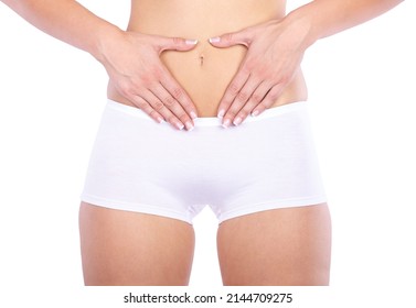 Nothing to worry about. Cropped studio shot of a woman measuring her waistline isolated on white.