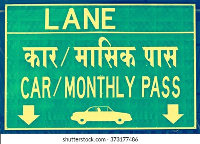 A Notice Board Showing A Lane For Car With Monthly Pass Vehicles At A Toll In Pune, India