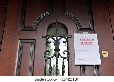 the notice of eviction of tenants hangs on the door of the house, front view - Shutterstock ID 1848201184