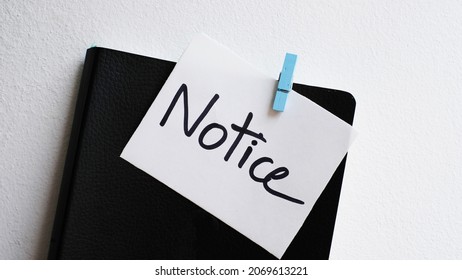 Notice message concept written post it on notebook.