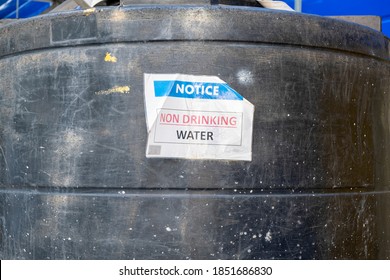 Notice On Large Industrial Black Plastic Water Tank Indicating Non Drinking Water. Stock Photograph.