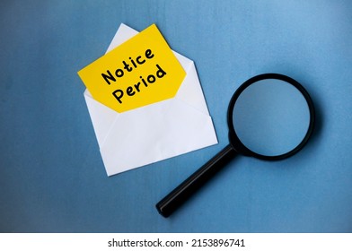 Notice period text on notepad in an envelope with magnifying glass on blue background. Employment concept - Shutterstock ID 2153896741