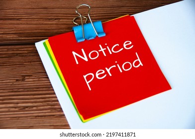 Notice Period Text On Red Notepad Wooden Desk Background. Resignation And Business Concept.