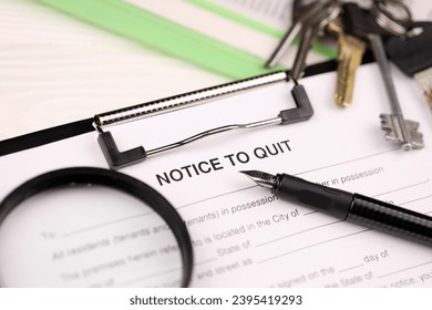 Notice to quit or eviction notice blank on A4 tablet lies on office table with pen and magnifying glass close up - Shutterstock ID 2395419293