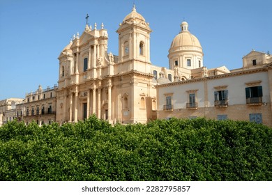 Noto – Sicily  -Italy – September 10, 2022: the Cathedral of Noto is a jewel of Sicilian baroque that is located on the main street full of other masterpieces of Baroque architecture. - Powered by Shutterstock