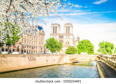 Notre Dame Cathedral On Cite Island Over The Seine River, Paris Cityscape At Spring, France