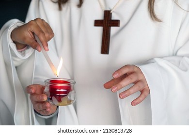 Notre-Dame-du-Val church. Catholic sunday mass.  Altar servers lighting a candle.  Bussy-Saint-Georges. France. 