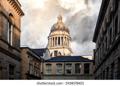 Nottingham city centre skyline with council house dome roof old buildings with sunshine and clouds lit up with golden hour light
