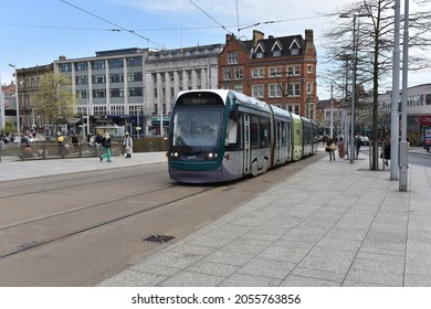Nottingham, England – October 08, 2021: The moder tram in Nottingam passes the tram stop Old Market Square in Nottingham city centre near to the Nottingham Council House. 