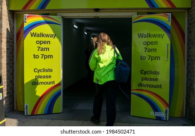 Nottingham, Nottinghamshire, England- June 1, 2021. Broadmarch Passage With Open Doors And Opening Hours Information And  Woman With Green Hi Vis Jacket Entering.