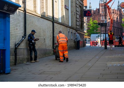 Nottingham, Nottinghamshire, England- June 1, 2021. Street Sweeper On His Back Dressed In Hi Vis Orange Clothing On The Exchange Walk Street.