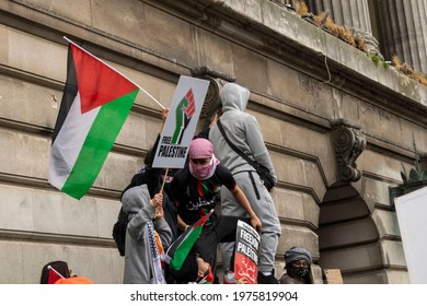 Nottingham, Nottinghamshire, England - May 15, 2021. Free Palestine protesters with placards and flag on top of Nottingham Council House.