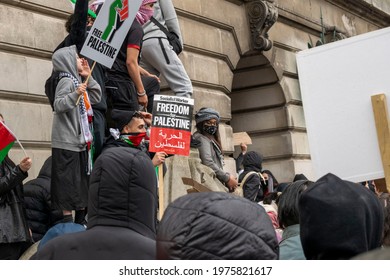 Nottingham, Nottinghamshire, England - May 15, 2021. Young protesters with placards "Free Palestine" on top of council house in the city centre.