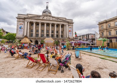 NOTTINGHAM, UK - AUGUST 07, 2019: Council House (City Hall) At Old Market Square With A Pool, Fountain, Sand And Beach Chairs In The Foreground.