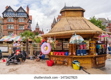 NOTTINGHAM, UK - AUGUST 07, 2019: Council House (City Hall) at Old Market Square with a pool, fountain, sand and beach chairs in the foreground.