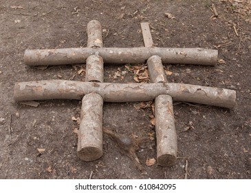 Noughts And Crosses (Tic Tac Toe) Hand Made From Logs Outdoor In The Village Of Arlington In Rural Devon, England, UK