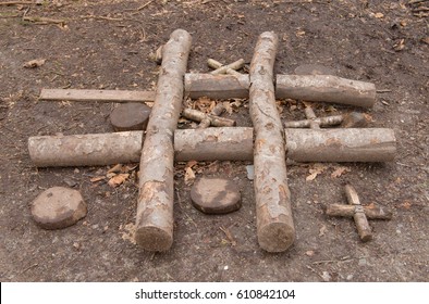 Noughts And Crosses (Tic Tac Toe) Hand Made From Logs Outdoor In The Village Of Arlington In Rural Devon, England, UK