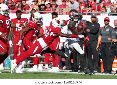 Nov 10, 2019; Tampa, FL USA;  Tampa Bay Buccaneers Wide Receiver Chris Godwin (12) Runs After A Catch While Arizona Cardinals Strong Safety Jalen Thompson (34) Tries To Make A Tackle.