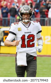 Nov 14, 2021; Landover, MD USA;  Tampa Bay Buccaneers quarterback Tom Brady (12) runs out to the field before an NFL game at FedEx Field. (Steve Jacobson, Image of Sport)