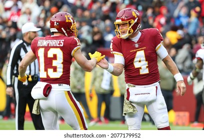 Nov 14, 2021; Landover, MD USA;  Washington Football Team quarterback Taylor Heinicke (4) celebrates with Adam Humphries (13) during an NFL game at FedEx Field. (Steve JacobsonImage of Sport)