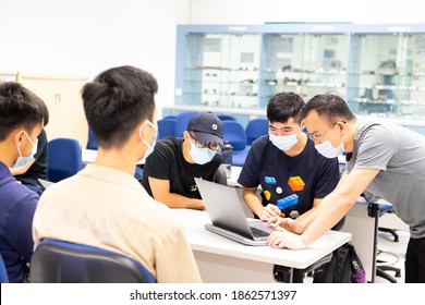 Nov 17 2020 Professor And Students With Face Mask And Computer Have Small Group Teaching And Discussion In Classroom In University In Hong Kong During Covid-19