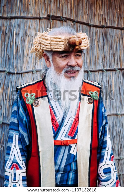 NOV 20, 2013 Hokkaido, JAPAN - A man in Ainu\
tradition tribal costume at Shiraoi Ainu Museum. The indigenous\
people of northern Japan.