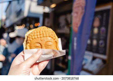 Nov 2021 - Kamakura, Japan: Kamakura's famous street food, the "Daibutsu-Yaki" , a cake with red beans or other fillings inside in shape of Buddha, and it will give you luck after eating.