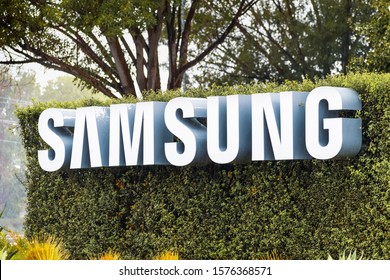 Nov 27, 2019 San Jose / CA / USA - Samsung Sign displayed in front of the modern headquarters of Samsung Electronics Device Solutions America in Silicon Valley; subsidiary of Samsung Electronics, Ltd