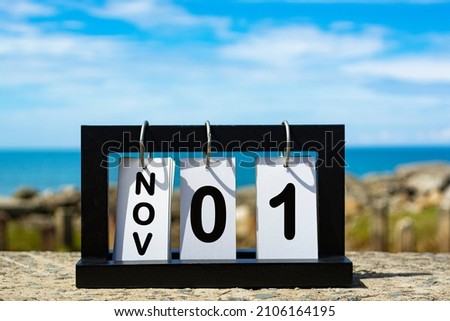 Nov 31 calendar date text on wooden frame with blurred background of ocean. Calendar concept