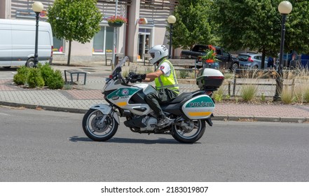 Nova Bana, Slovakia - July, 24, 2022 : Visegrad 4 Bicycle Race 2022. Police Motor Cycle Escort Rider At Road Bicycle Race.