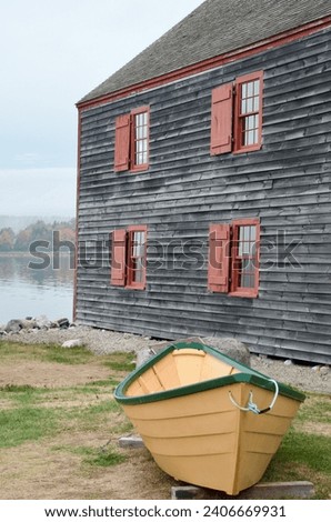 Nova Scotia Shelburne Village Yellow Dory Boat beside warehouse