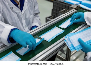 As the novel pneumoconiosis coronavirus spreads worldwide, medical mask automation machines are in continuous 24-hour production to prepare for the COVID-19 outbreak. - Shutterstock ID 1665408055