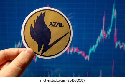 November 10, 2021, Baku, Azerbaijan. The Emblem Of Azerbaijan Airlines Against The Background Of A Share Price Chart.