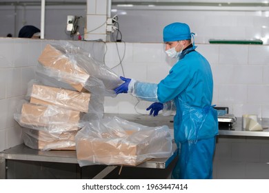 November 13, 2020. Belarus, Gomil Region. Meat Factory. An Enterprise Worker In A Protective Suit And A Medical Mask Is Packing Boxes.