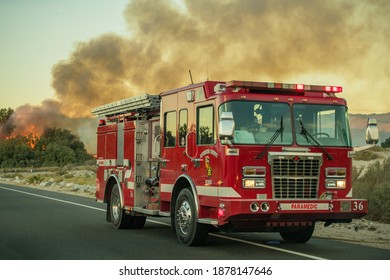 November 15th, 2017. Palm Springs, California, USA. California Riverside County Firetruck on the Side of the Road with Wildfire Fighting Nearby. 