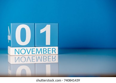 November 1st. Day 1 of last autumn month, calendar on blue background. Empty space for text