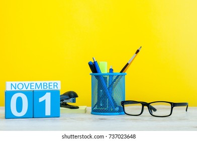 November 1st. Day 1 Of Month, Wooden Color Calendar On Yellow Background With Office Supplies. Autumn Time