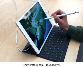 November 2019 Bologna, Italy: Boy Playing On Ipad With Keyboard And Apple Stylus Close-up. Boys' Hands With Stilus. Apple Store