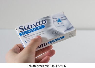 November 2019, Swansea, UK. Box of Sudafed, pharmaceutic product, relieving nasal and sinus congestion.
Holding the box on a white background.