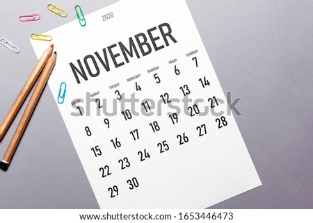 November 2020 simple calendar with office supplies and copy space