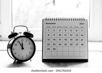 November 2021 grayscale calendar - month page showing date on wooden table