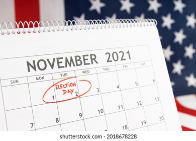 November 2021 USA Election Day Concept. Desk Calendar With November 2rd Marked In Red And USA Flag At Background