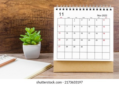 The November 2022 desk calendar on wooden table.